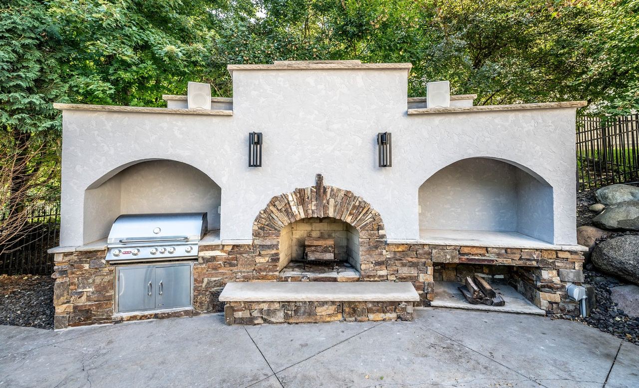 Outdoor fireplace and grill station in Rosemount, MN, wide view